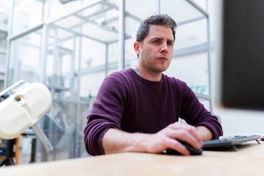 A engineer looks intrigued by his computer